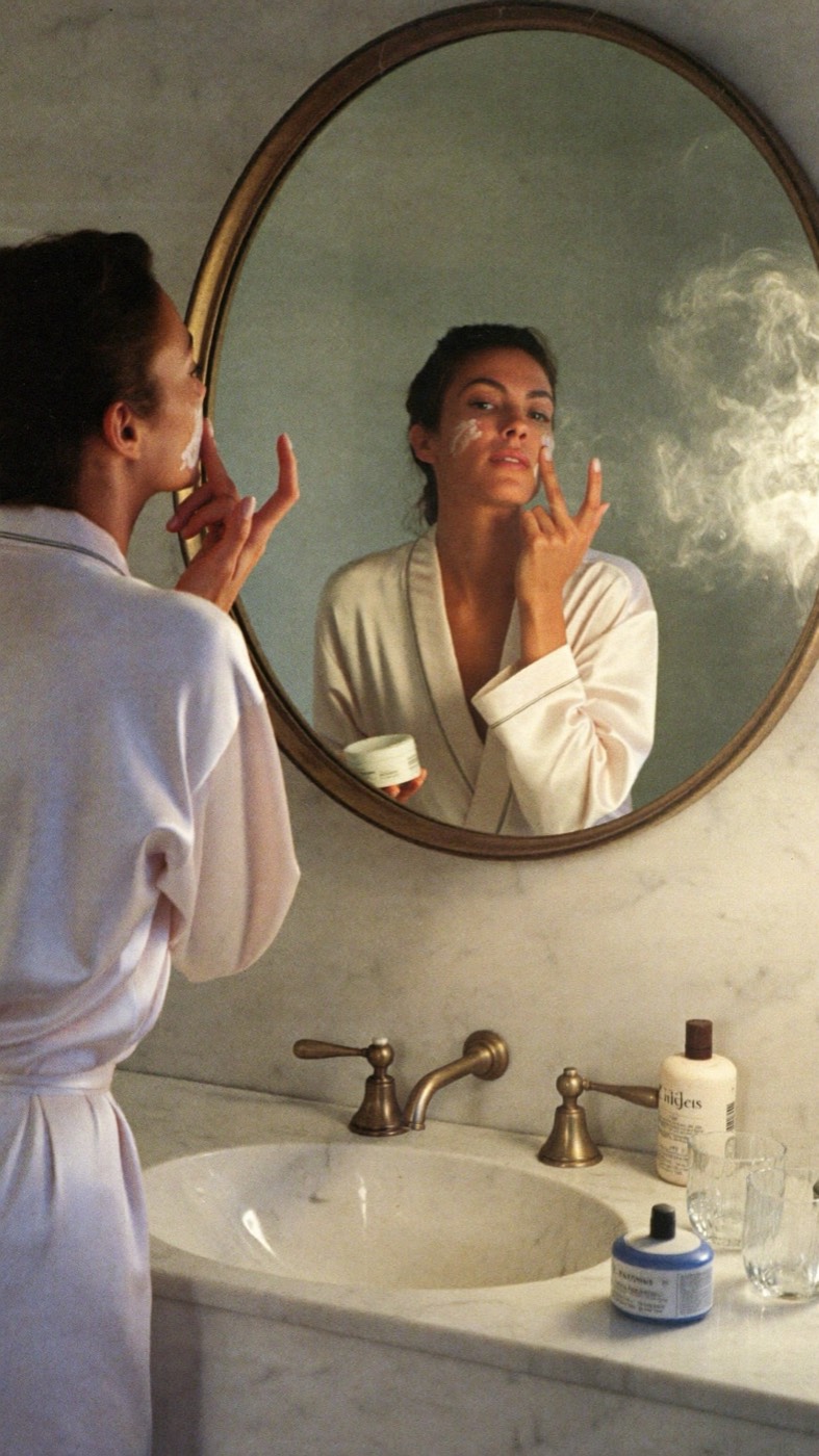 Skincare ritual at a brass mirror